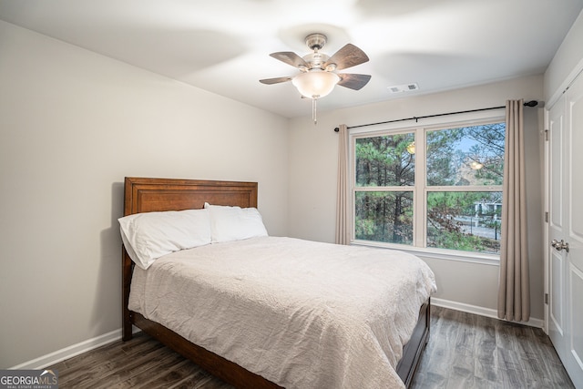 bedroom featuring a closet, ceiling fan, and dark wood-type flooring