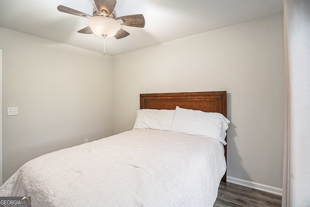 bedroom featuring ceiling fan and dark wood-type flooring