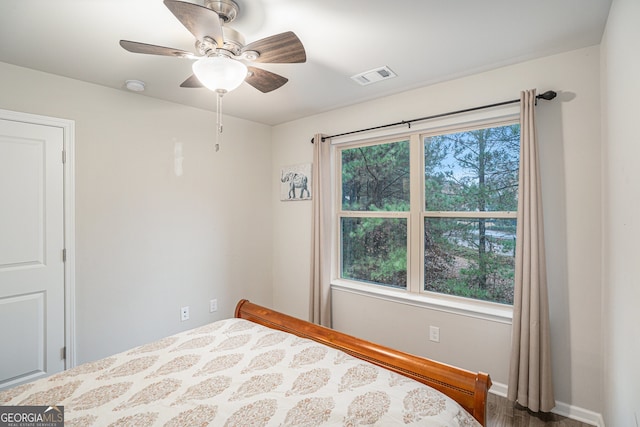 bedroom with ceiling fan and hardwood / wood-style flooring