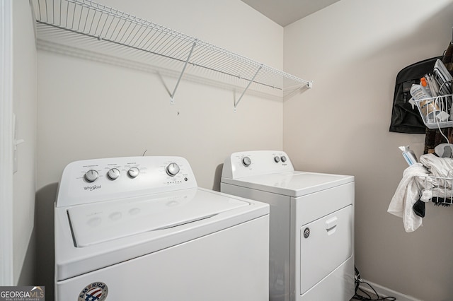 clothes washing area featuring washer and clothes dryer