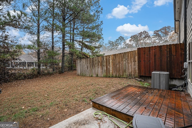 view of yard featuring central AC unit and a deck