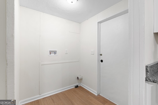 laundry area featuring hardwood / wood-style floors and washer hookup