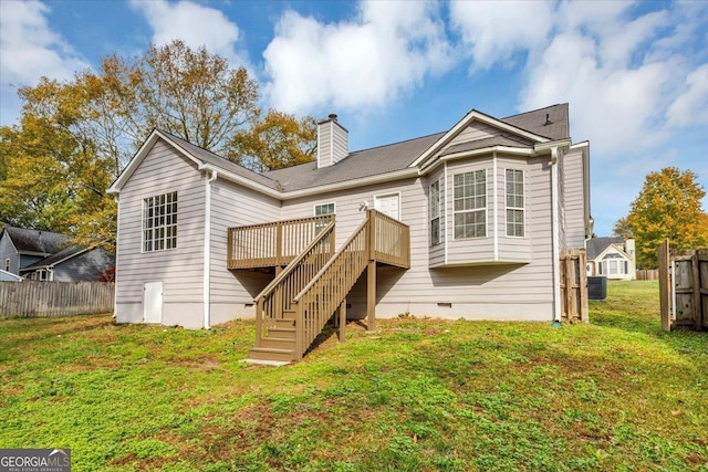 back of property with central air condition unit, a wooden deck, and a yard