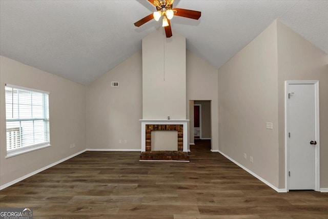 unfurnished living room featuring high vaulted ceiling, dark hardwood / wood-style floors, ceiling fan, a textured ceiling, and a fireplace