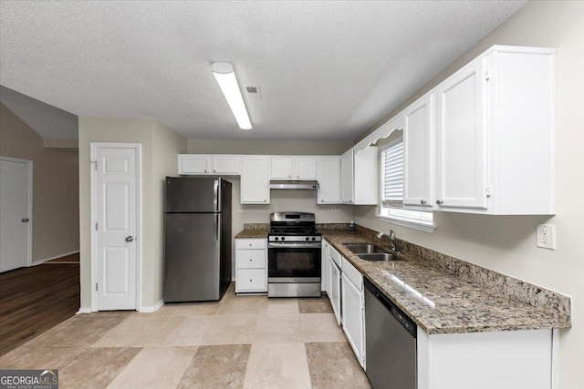 kitchen featuring sink, white cabinets, stainless steel appliances, and stone countertops