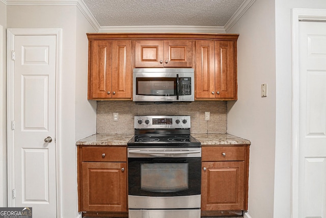 kitchen with stainless steel appliances, light stone counters, and tasteful backsplash