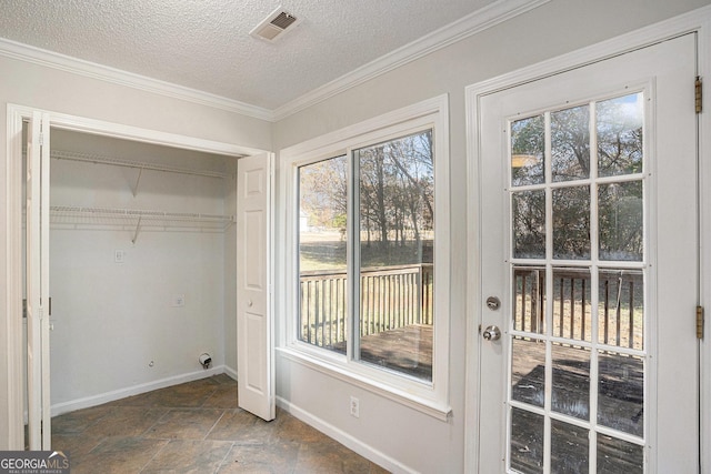 entryway with a textured ceiling and ornamental molding