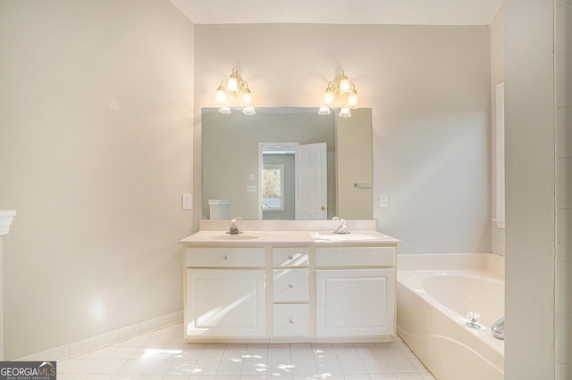 bathroom featuring tile patterned floors, a bathtub, and vanity