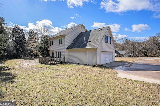 back of property featuring a yard and a garage