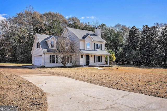 view of property featuring a porch and a garage