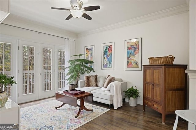 sitting room featuring french doors, dark hardwood / wood-style floors, ceiling fan, and crown molding