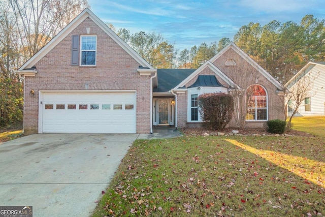 view of property featuring a front yard and a garage