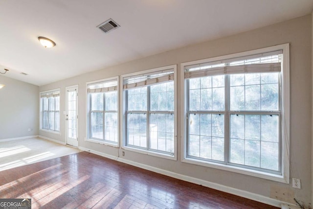 unfurnished room with hardwood / wood-style floors