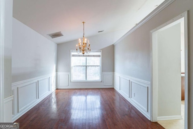 unfurnished dining area with dark hardwood / wood-style flooring, vaulted ceiling, and an inviting chandelier