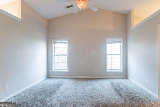 carpeted empty room featuring ceiling fan and high vaulted ceiling