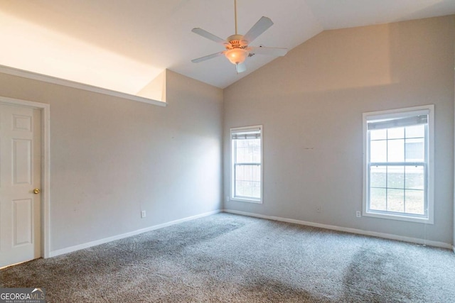 carpeted spare room featuring high vaulted ceiling, plenty of natural light, and ceiling fan