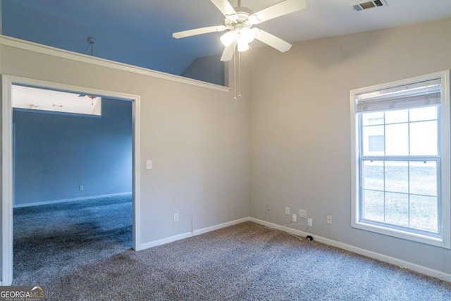 carpeted empty room with ceiling fan, lofted ceiling, and a wealth of natural light