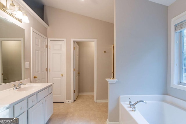 bathroom featuring a washtub, vanity, and lofted ceiling