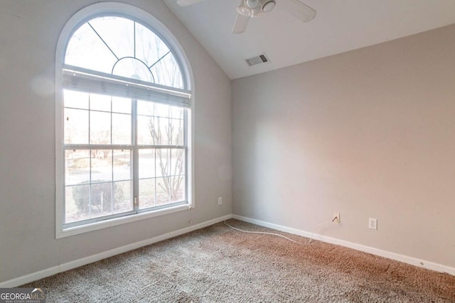 carpeted spare room with ceiling fan and lofted ceiling