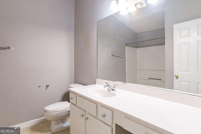 bathroom with tile patterned floors, vanity, toilet, and walk in shower