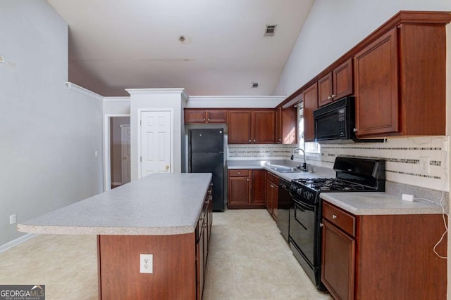 kitchen with tasteful backsplash, crown molding, sink, black appliances, and a kitchen island