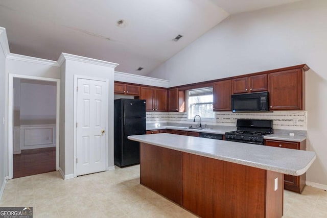 kitchen with backsplash, sink, a kitchen island, and black appliances