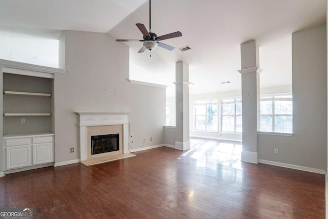 unfurnished living room featuring ceiling fan, built in features, dark wood-type flooring, and high vaulted ceiling