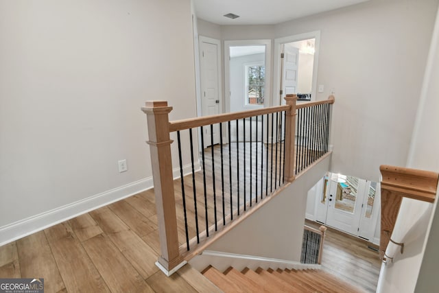 stairway featuring hardwood / wood-style flooring