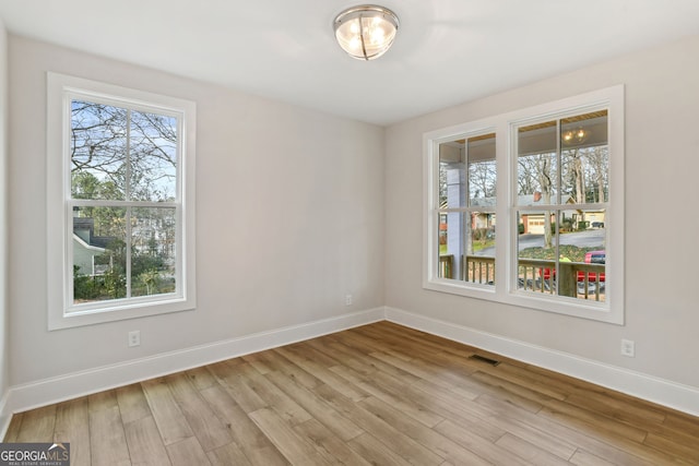 unfurnished room with light hardwood / wood-style flooring