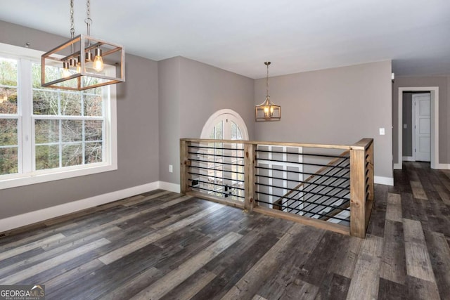 unfurnished dining area featuring dark hardwood / wood-style flooring and plenty of natural light