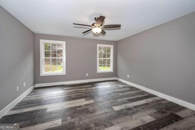 empty room featuring dark hardwood / wood-style floors, plenty of natural light, and ceiling fan