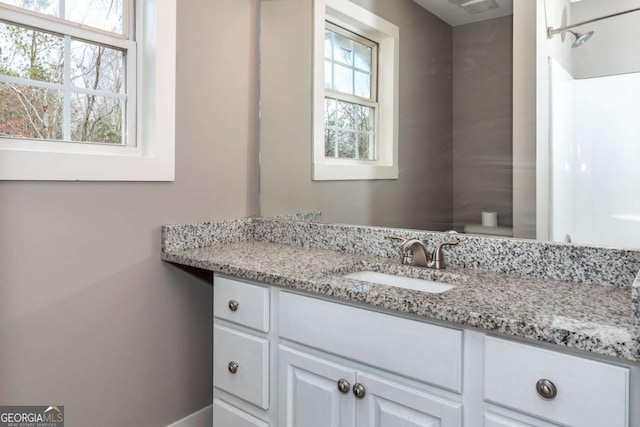 bathroom with vanity and toilet