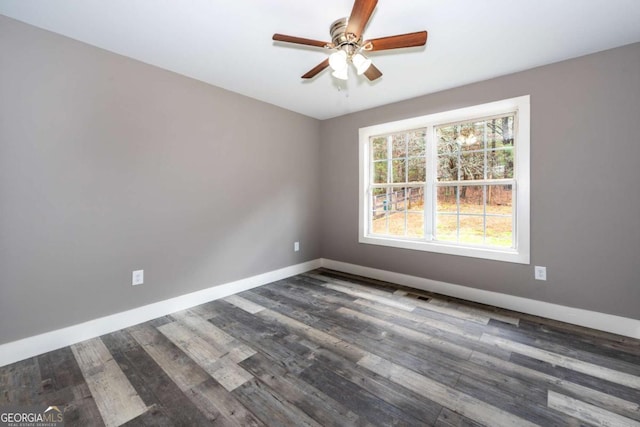 empty room featuring ceiling fan and dark hardwood / wood-style flooring