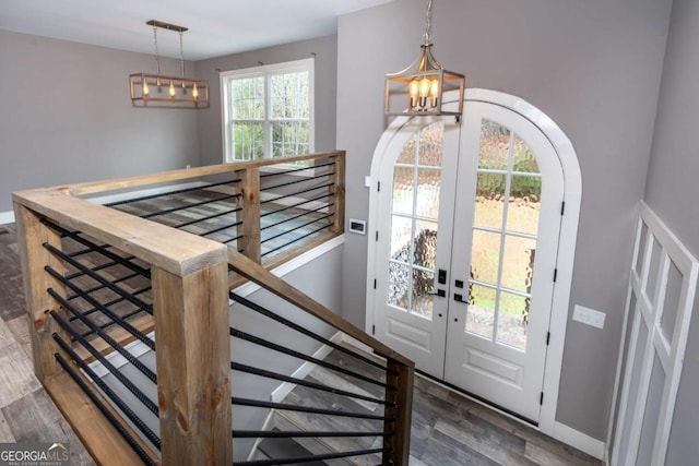 entryway featuring dark hardwood / wood-style flooring, a wealth of natural light, and french doors