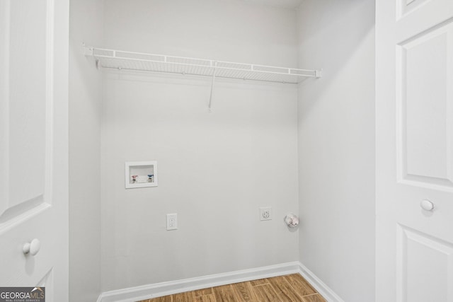 laundry area featuring wood-type flooring, hookup for a washing machine, and electric dryer hookup