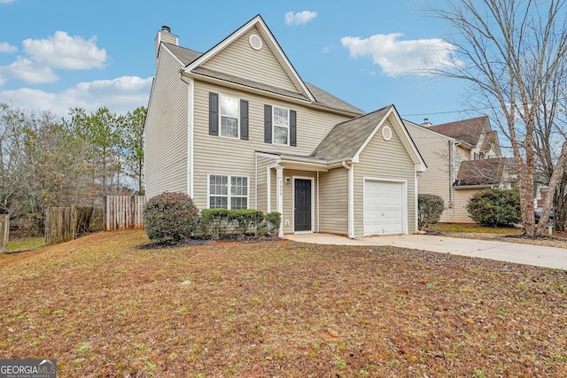 view of property featuring a garage and a front lawn