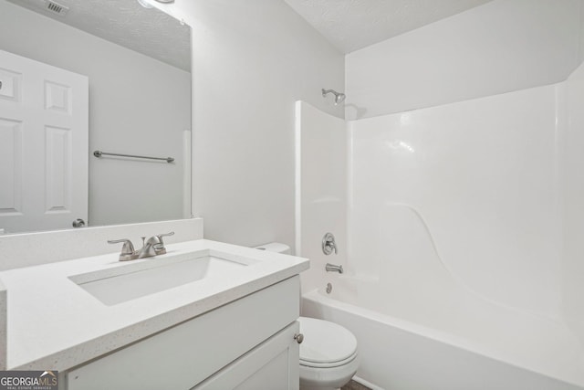 full bathroom with vanity, shower / tub combination, a textured ceiling, and toilet