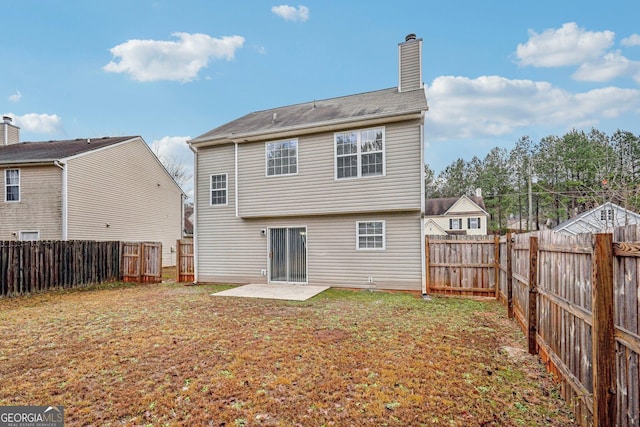 back of house featuring a yard and a patio