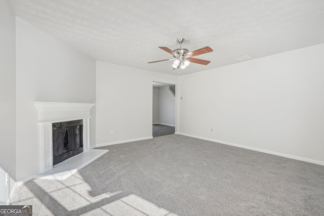 unfurnished living room featuring a textured ceiling, ceiling fan, and light carpet