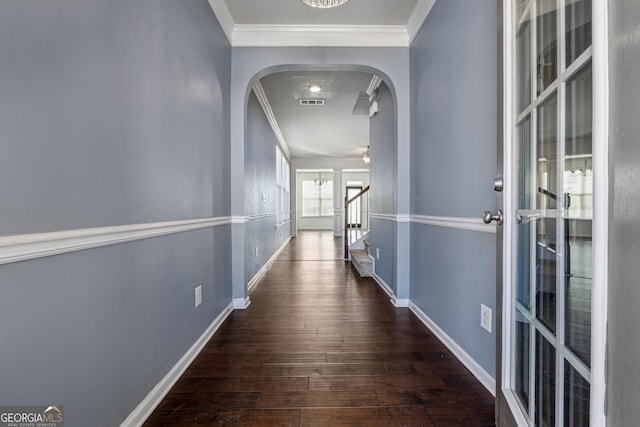 corridor featuring dark hardwood / wood-style floors and crown molding