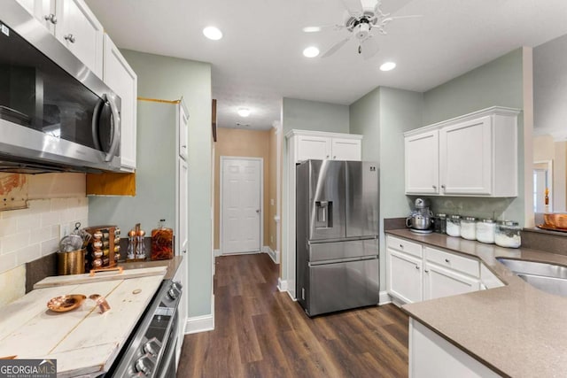 kitchen featuring tasteful backsplash, stainless steel appliances, ceiling fan, dark wood-type flooring, and white cabinets