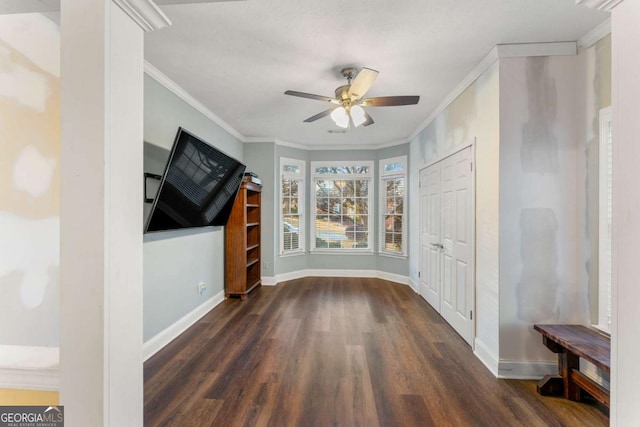 interior space with dark hardwood / wood-style flooring, ceiling fan, and crown molding