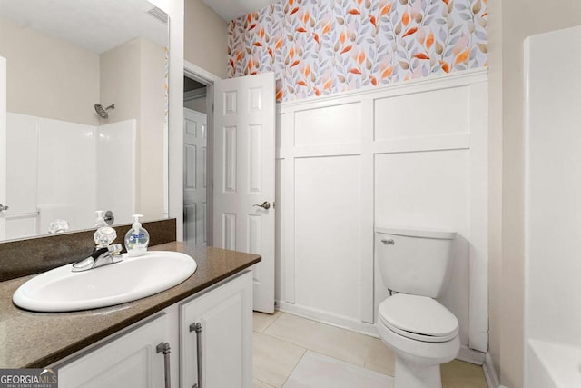 bathroom with tile patterned flooring, vanity, and toilet