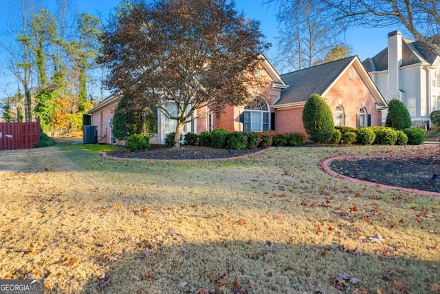 view of front of property featuring a front lawn and central AC unit