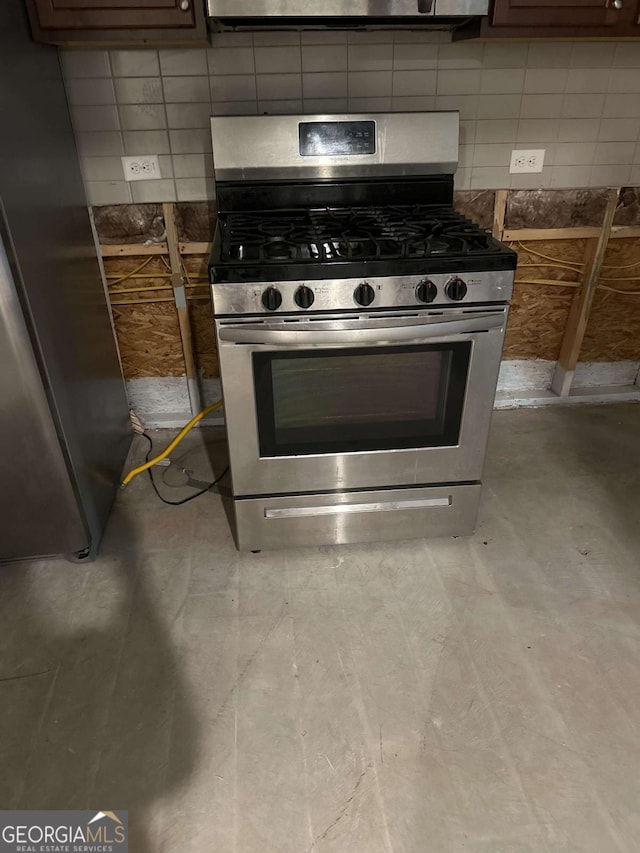 kitchen with dark brown cabinetry, appliances with stainless steel finishes, and tasteful backsplash