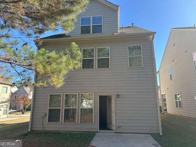 rear view of house with a yard