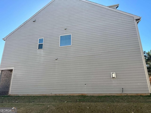 view of property exterior featuring a lawn