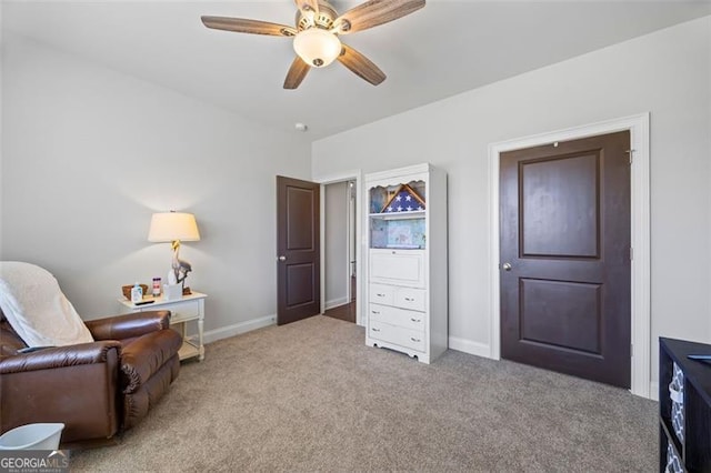 living area with carpet floors, ceiling fan, and baseboards