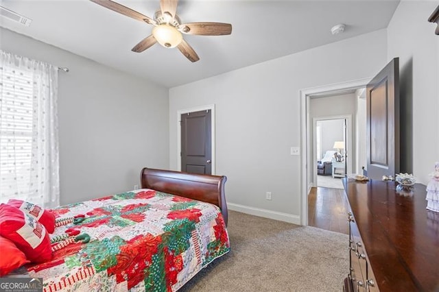 bedroom with baseboards, visible vents, ceiling fan, and carpet flooring