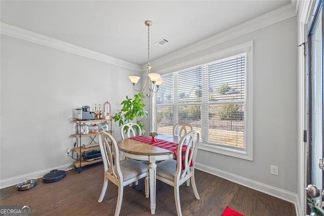 dining area featuring a notable chandelier, baseboards, dark wood-style flooring, and crown molding